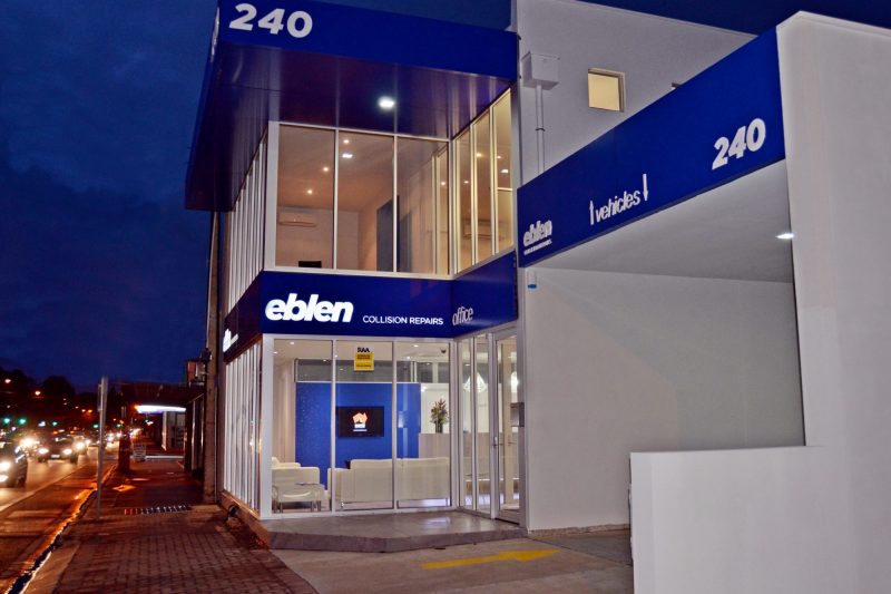 Custom built commercial building. Glass front with blue signage.