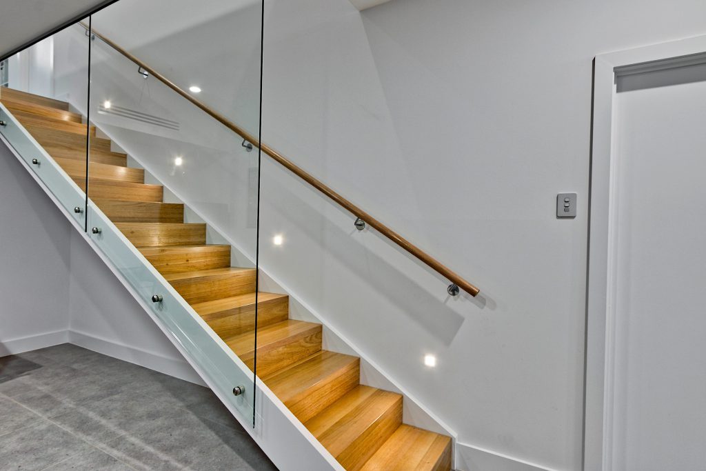 No longer an unfinished home: modern staircase with glass panels